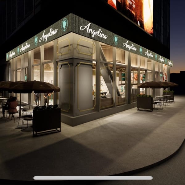 Evening rendering of an Angelina corner storefront with illuminated signage and outdoor cafe seating under umbrellas.