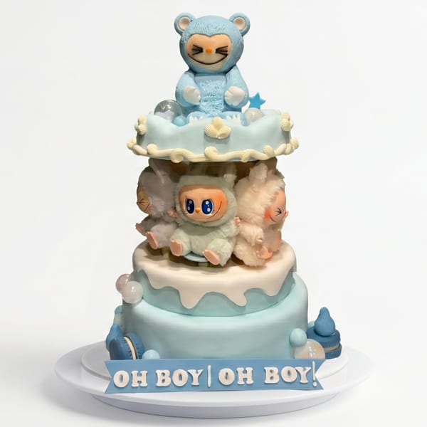 A three-tiered baby shower cake with blue and white frosting, topped with cute animal figurines.