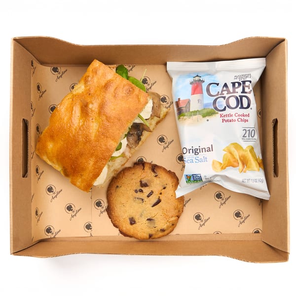 Boxed lunch with a focaccia sandwich, chocolate chip cookie, and Cape Cod chips in an Angelina box.